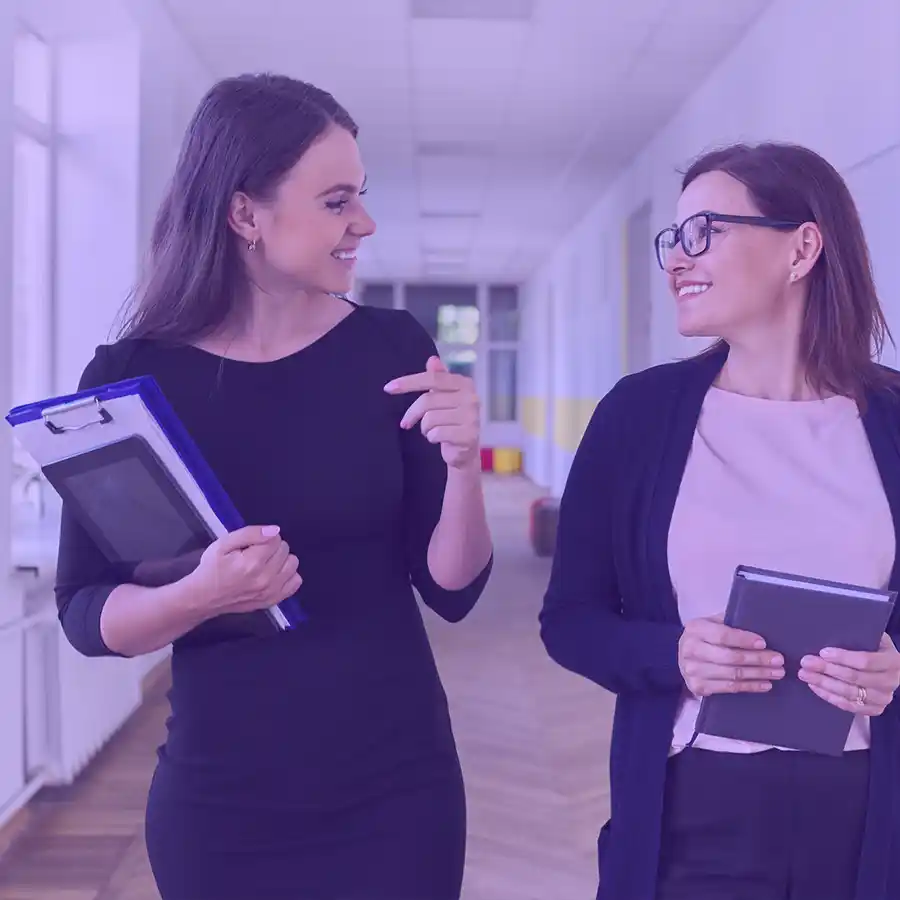 Two teaching professionals walking and talking